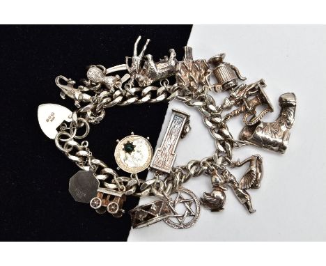 A HEAVY SILVER CHARM BRACELET, curb link bracelet each link stamped with a sterling mark, fitted with twenty charms in forms 