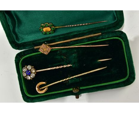 FOUR STICK PINS, to include a blue and colourless paste cluster stick pin, unmarked, a 9ct gold floral detailed stick pin hal