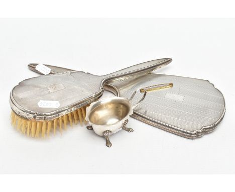 A SILVER VANITY MIRROR AND HAIR BRUSH WITH A SILVER SALT, the hand held mirror and matching hair brush with an engine turned 