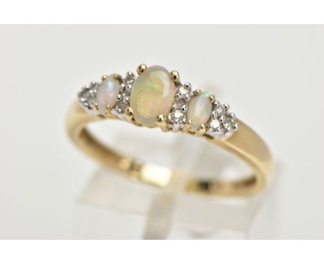 A 9CT GOLD OPAL AND DIAMOND RING, an oval opal and two marquise shaped opals set with ten round brilliant cut diamonds, prong