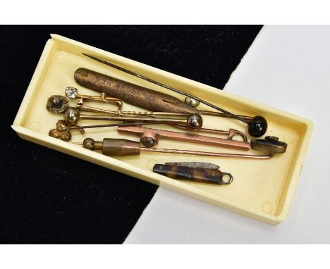 ASSORTED YELLOW METAL STICK PINS, to include a bar brooch set with a round cabochon colourless gemstone, in a milgrain settin