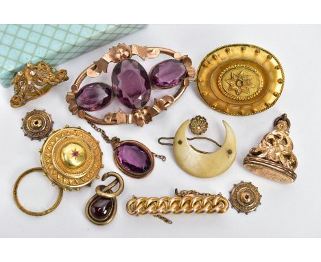 AN ASSORTMENT OF VICTORIAN YELLOW METAL BROOCHES, to include an open work rose metal and purple paste brooch, a floral yellow