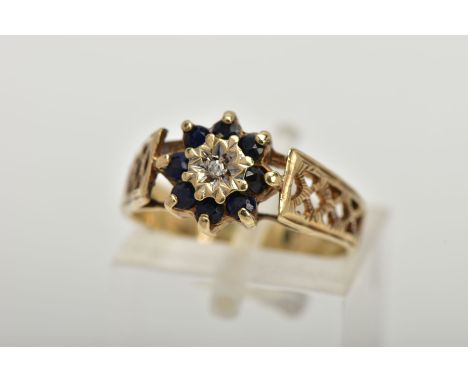 A 9CT GOLD SAPPHIRE AND DIAMOND CLUSTER RING, set with a central illusion set single cut diamond in a surround of circular cu