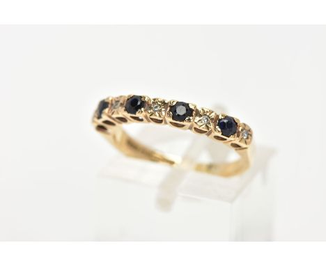 A 9CT GOLD SAPPHIRE AND DIAMOND HALF ETERNITY RING, designed with four circular cut deep blue sapphires, interspaced with ill