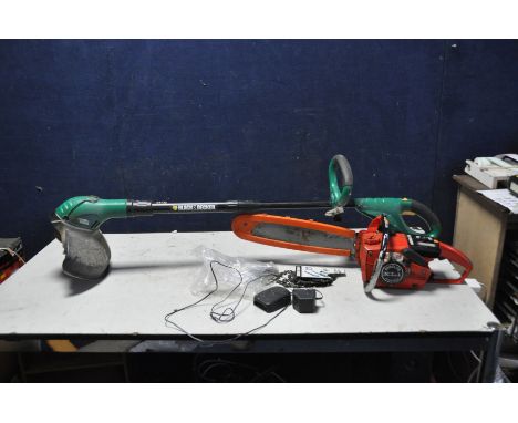 A VINTAGE HOMELITE XL1 AUTOMATIC PETROL CHAINSAW with 2 spare blades (engine pulls freely but hasn't been started), a Black a