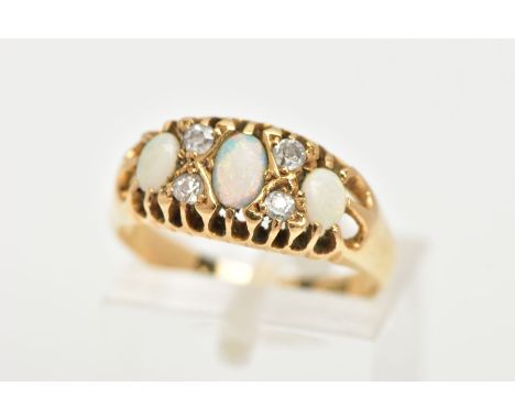 A YELLOW METAL OPAL AND DIAMOND RING, designed with three oval cut opal cabochons, interspaced with four old cut diamonds, op