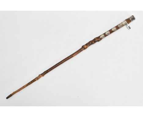 A SILVER MOUNTED COMMEMORATIVE WALKING STICK, unworked stick with nobbly protrusions, mounted with a white metal square plaqu
