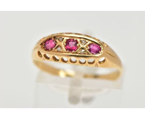 A YELLOW METAL RUBY BOAT RING, three circular cut rubies, prong set with four old cut diamonds in a yellow metal boat mount, 