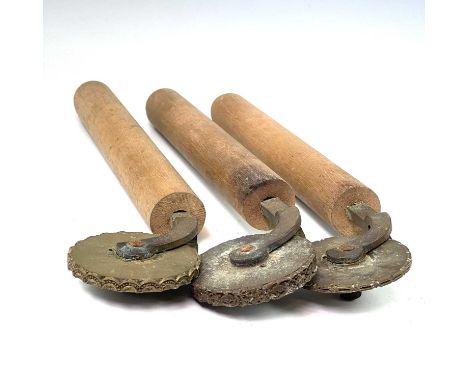 Three leatherworkers tools, each with embossed brass wheel and turned handle, length 41.5cm.