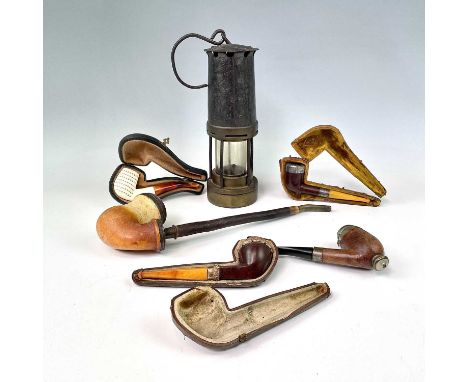 A brass and painted steel miner's lamp, height 26cm, together with a silver and amber mounted pipe, cased, and four other ass