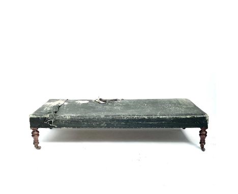 A Victorian mahogany framed day bed couch or Ottoman, with later rexine upholstery and raised on turned legs with patent cera