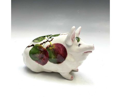 A Wemyss Exon figure of a pig, painted with apples, impressed and painted marks, number 2599, signed B Adams, length 17cm.
