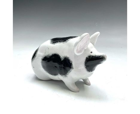 A Wemyss pig, with black and white sponged markings, seated on its haunches, impressed mark, length 15.5cm.Tiny chip to tips 