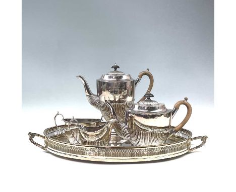 A silverplate tea and coffee service comprising coffeepot, teapot, twin handled sugar bowl, milk jug and serving tray, inscri