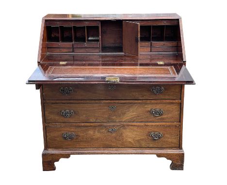 A George III mahogany bureau, the fall front enclosing a fitted interior, above four long drawers, on bracket feet, height 10