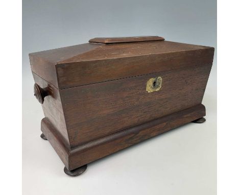 A William IV rosewood sarcophagus shape tea caddy, with original glass bowl and twin lidded compartments, on disc feet, width