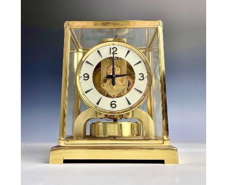 A Jaeger LeCoultre Atmos mantel clock, with gilt edged white circular chapter ring, serial number 195375, height 22.5cm.The J