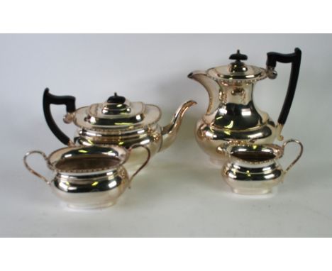 FOUR PIECE ELECTROPLATED TEA SET, of rounded oblong form with angular scroll handles, bobbin and reel borders and rounded obl