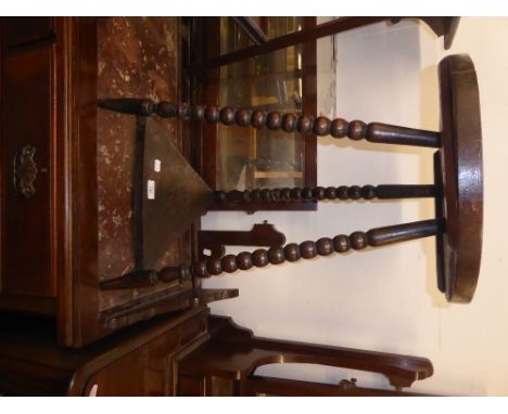 A TWO TIER TORCHERE STAND WITH CIRCULAR TOP ON THREE BOBBIN TURNED LEGS 