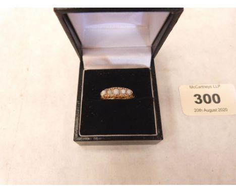 An Edwardian 18ct ring set with five opals. Size O½. 3.2g gross