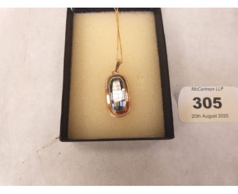 A 14ct pendant and chain set with a light blue stone. Chain 9ct. 4g gross