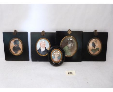 Four Regency ebonised miniature frames, two with silhouettes, one with portrait and another with a photograph; together with 
