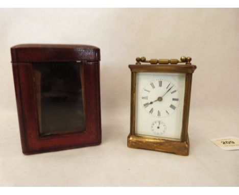 An early 20th century French brass carriage timepiece with alarm and leather travelling case. The clock 4¼' high. Movement ru