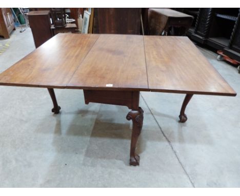 An 18th century mahogany dropleaf dining table raised on shell and scale moulded cabriole legs with ball and claw feet. 48' w