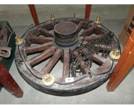 An oak iron rimmed wagon wheel light fitting. 26' diam