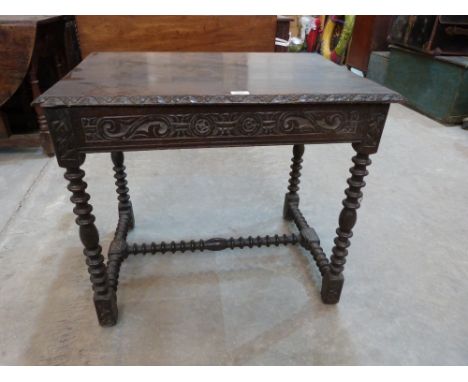 A 17th century joined oak side table with scroll carved frieze, on bobbin turned legs and stretchers. 31' wide