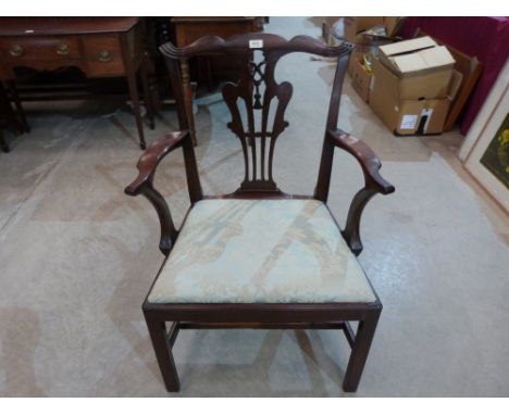 A George III mahogany elbow chair of Chippendale style, on moulded chamfered square legs