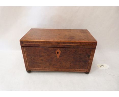 A Regency yew wood, line inlaid and banded two division tea caddy on gilt brass ball feet. 10' wide