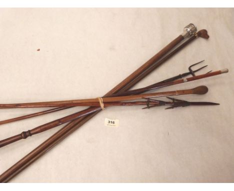A silver topped walking stick; swagger stick with silver pommel; carved lady's stick; a bamboo stick; a turned toasting fork 