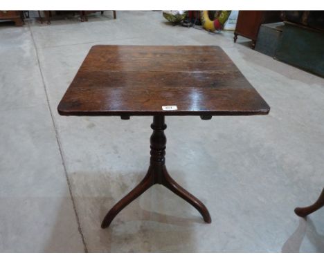 A George III oak snap-top table, the square top on ring turned column and tripod support. 22' wide