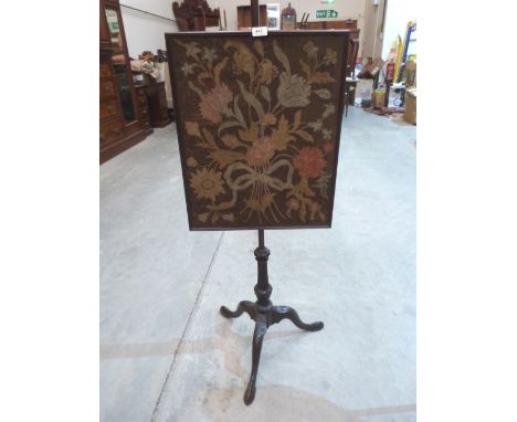 A 19th century mahogany polescreen with tapestry banner, on carved tripod support. 52' high