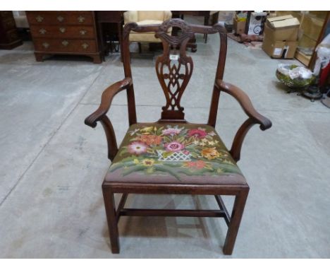A George III mahogany 'Chippendale' elbow chair, the foliate carved back with tracery pierced splat, on chamfered square moul