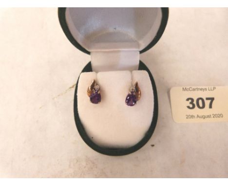 A pair of 9ct amethyst and diamond earrings. 1.2g gross