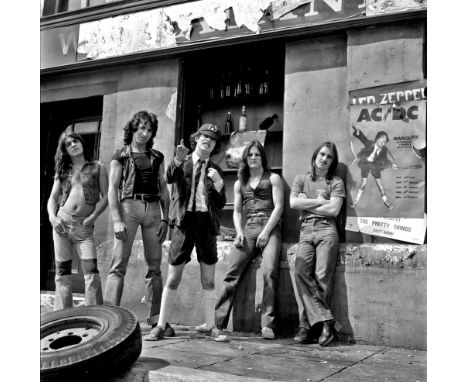 A high-quality photo print depicting AC/DC, taken by photographer Martyn Goddard in 1976. The photo depicts the group posing 