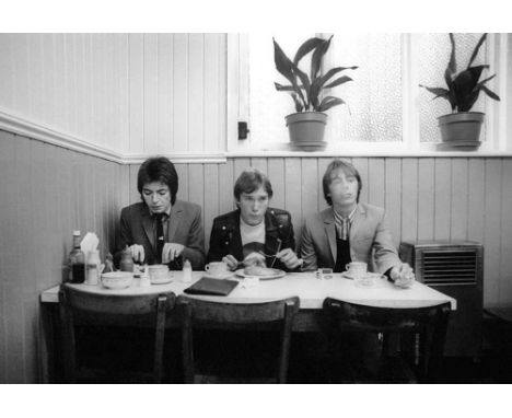 A high-quality photo print depicting The Jam, taken by photographer Martyn Goddard in 1978. The photo depicts the band taking