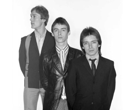 A high-quality photo print depicting The Jam, taken by photographer Martyn Goddard in 1977. The photo depicts the band posing