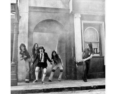 A high-quality photo print depicting AC/DC, taken by photographer Martyn Goddard in 1976. The photo depicts the group posing 