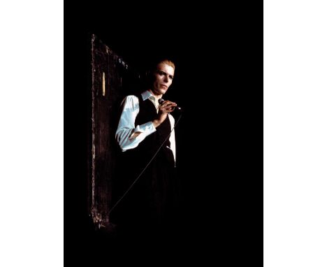 A high-quality photo print of a portrait of David Bowie on stage, taken by photographer Philippe Auliac in 1976. Measures 30x