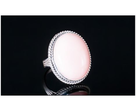 Pink Opal Solitaire Ring, an oval cut cabochon of a generous 28cts of the ethereal pink oval, mined in Peru, in a hand crafte