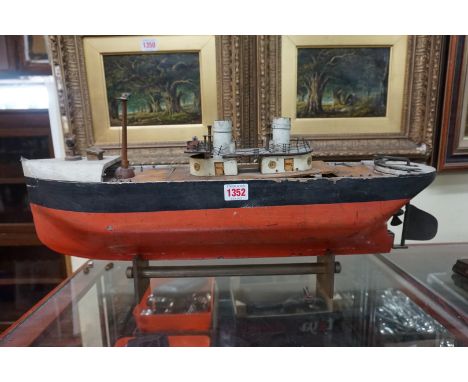 An early 20th century clockwork ocean liner, possibly Bing or Marklin, 63cm long, on brass stand. 