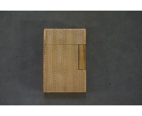 A vintage Dupont Ligne gold plated lighter, with engine turned decoration, 5.5cm high.&nbsp; 