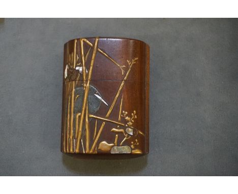 A good Japanese wood, gilt lacquer, mother-of-pearl inro and cover, Meiji, signed to base, decorated with a stork amongst ree