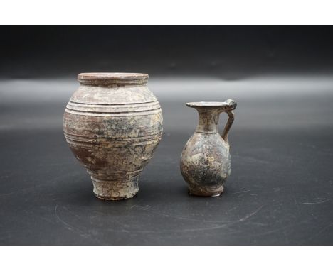 Antiquities: a pottery vase and similar ewer, possibly Roman, 9.5cm and 7.5cm respectively. 