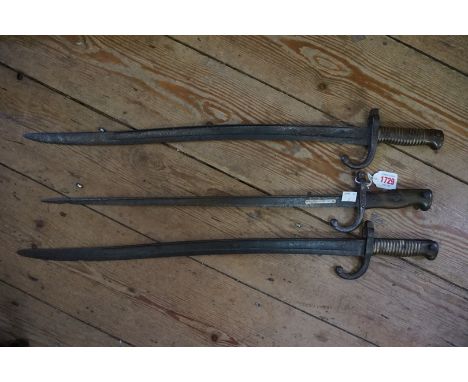 Two French M1866 yataghan sword bayonets; together with a French 1874 T-back bayonet, (each in relic condition). (3) 