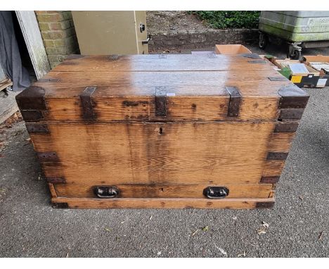 A large oak and metal bound trunk, 96.5cm wide x 60cm high x 59cm deep. 