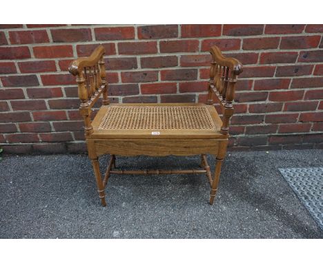 An old walnut and cane commode stool, 58.5cm wide. 
